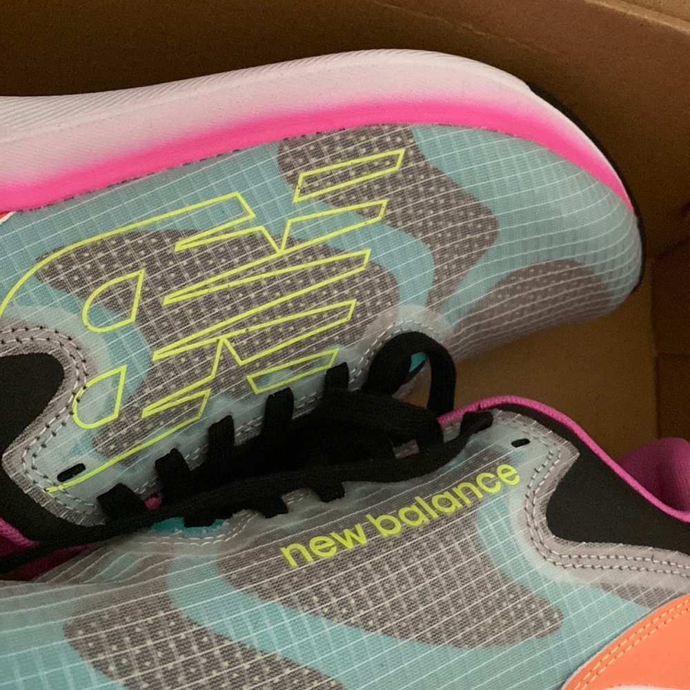 New Balance tennis shoes. Multi colored,NWT only tried on.  Never worn.